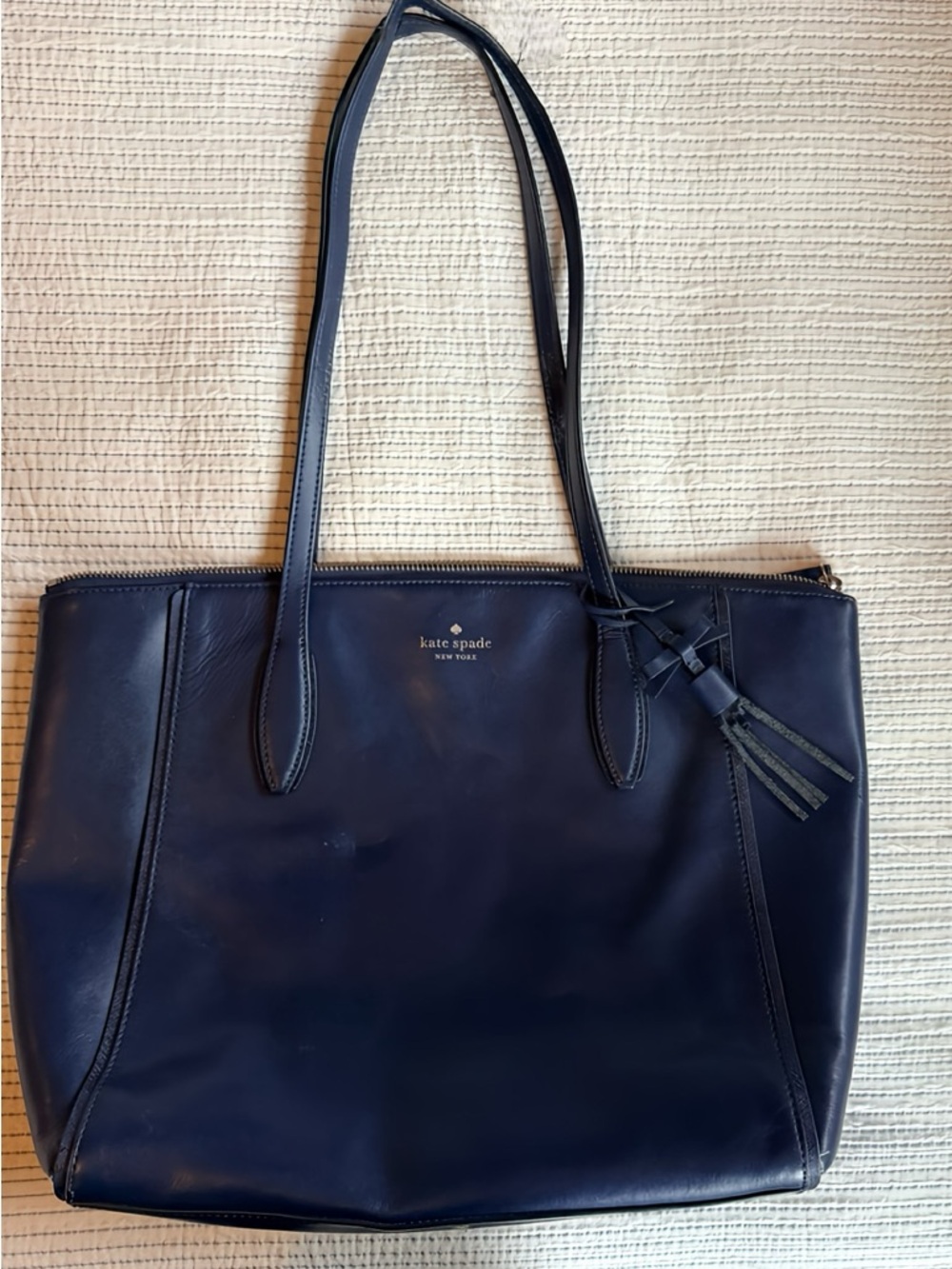 Classic Kate Spade Navy Leather Tote with Tassel.